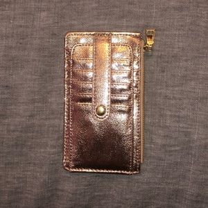 Shimmery rose gold wallet.